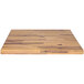 A rectangular faux wood melamine riser on a wooden table with a white background.