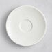 A white RAK Porcelain saucer with a circular center pattern.