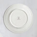 A RAK Porcelain ivory flat plate with an embossed crown logo on the rim.