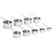 A group of stainless steel measuring cups with wire handles.