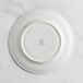 A RAK Porcelain ivory flat plate with an embossed crown design.