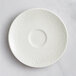 A white RAK Porcelain saucer with a floral design.