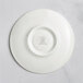 A white porcelain saucer with an embossed circle on it.