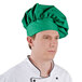 A man wearing a green Intedge chef hat.