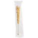 A plastic bag with a white and gold wrapped Roses Dryden and Palmer rock candy swizzle stick.