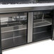 A Turbo Air stainless steel refrigerated sandwich prep table with 3 doors on a counter.