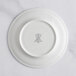 A white RAK Porcelain plate with an ivory embossed crown logo.