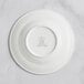 A RAK Porcelain ivory deep plate with an embossed crown logo on the wide rim.