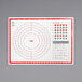 A white OXO silicone mat with red circle and measurements.