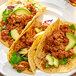A plate of tacos with Regal Mexican Chorizo Sausage meat and vegetables.