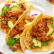 A plate of tacos with Regal Mexican Chorizo sausage and vegetables.