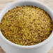 A bowl of yellow and brown spices including Regal Lemon Pepper Wing Rub.