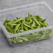 A plastic container filled with Sugar Snap Peas.