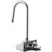 A chrome Waterloo hands-free sensor faucet with a gooseneck spout over a hole in a counter.