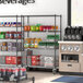 A Steelton wire shelving kit with casters in a grocery store aisle holding beverages.