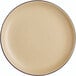 A close up of an Acopa Harvest Tan Matte Coupe stoneware plate with a black rim.