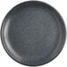 An Acopa Midnight Blue matte coupe stoneware plate with speckles on it.