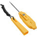 A yellow AvaTemp digital pocket probe thermometer with a black cord on a counter.