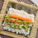 A sushi roll with rice and fish wrapped in Blue Sushi Nori Seaweed.