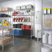 Regency Chrome wire shelving kit in a school kitchen with shelves of food.