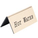 A gold metal Cal-Mil hot water tent with black text that reads "hot water" on a counter.