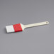 A white and red Choice basting brush with plastic handle.