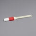 A white and red Choice pastry and basting brush with plastic handle.