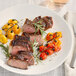 A plate of steak and tomatoes seasoned with Regal Texas-Style Steak Seasoning.