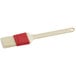 A natural bristle pastry and basting brush with a white plastic handle.