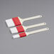 A Choice 3-piece pastry and basting brush set with white bristles and red handles.