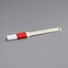 A white and red Choice pastry and basting brush with a plastic handle.
