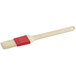 A natural bristle pastry/basting brush with a white plastic handle.