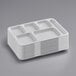 A stack of white rectangular Choice heavy-duty melamine 6 compartment trays.