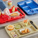 A right handed tan melamine compartment tray with food in it.