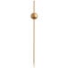 A wooden toothpick with a gold ball on the end.