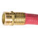 A close-up of a red Notrax commercial hot water hose with brass connectors.