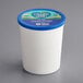A white container of Follow Your Heart Dairy-Free Vegan Cream Cheese with a blue lid.