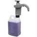 A purple plastic Dema FlexDose portable dosing dispenser with a white lid and a handle.