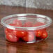 A clear Fabri-Kal deli container lid with cherry tomatoes inside.