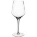 A close-up of a clear Della Luce Astro 16 oz. wine glass with a long stem.