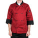 A man wearing a Chef Revival red and bronze chef jacket with black pants.