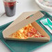 A pizza slice in a Sabert kraft cardboard box.