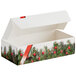 A white candy box with a red and green tree and berry print.