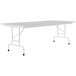 A gray rectangular folding table with black legs.