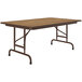 A brown rectangular Correll folding table with metal legs and a wood top.