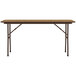 A brown rectangular Correll folding table with a medium oak top and legs.