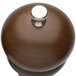 A Chef Specialties pepper mill with a silver knob on a brown surface.