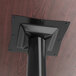 A Lancaster Table & Seating black bar height column table base with a black pole on the ceiling.