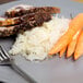 A plate of food with carrots and Star Cross sauerkraut on it with a fork.