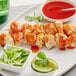 Chicken skewers with Sauce Craft Honey Sriracha sauce and green garnish on a plate.